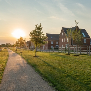 Empty walkway path at sunset near new build housing area