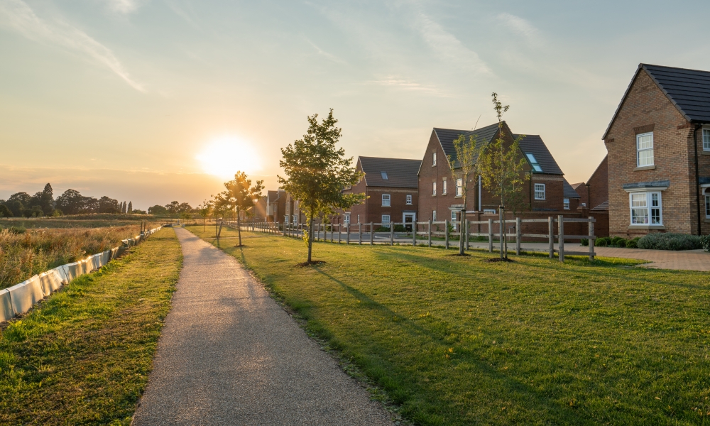 Empty walkway path at sunset near new build housing area